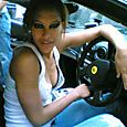 Christina behind the wheel of a Ferari